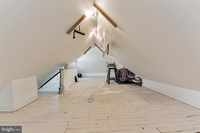 bonus room featuring vaulted ceiling and wood-type flooring