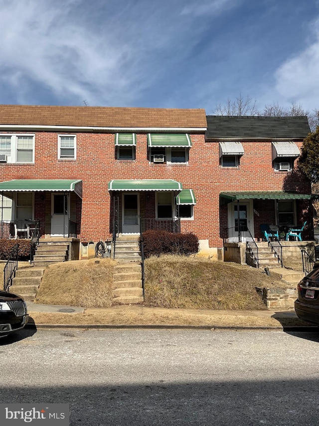 townhome / multi-family property with brick siding