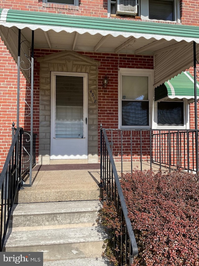 property entrance featuring brick siding