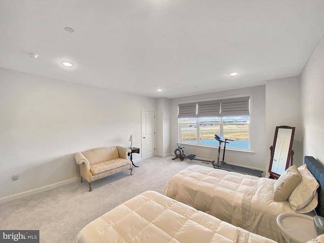 bedroom with recessed lighting, light colored carpet, and baseboards