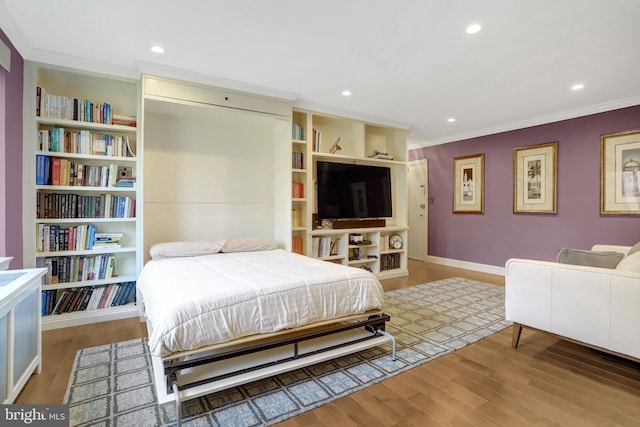 bedroom with crown molding and wood-type flooring