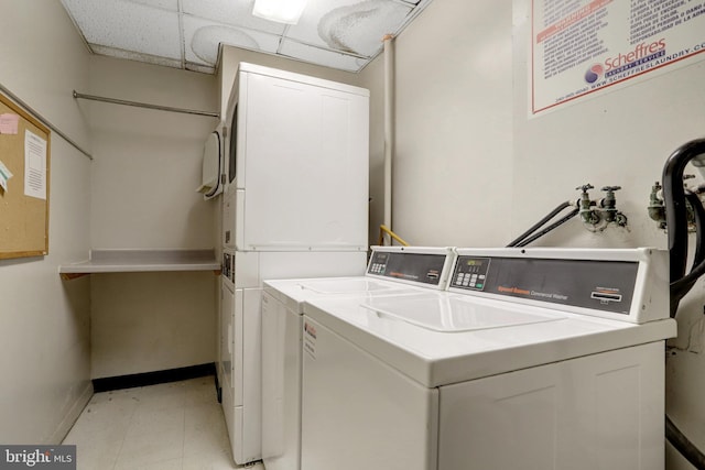 laundry area with stacked washer / dryer and washer and clothes dryer