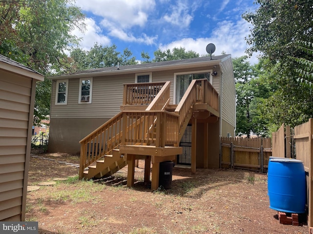 back of house with a deck