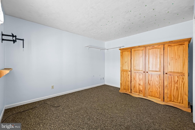 unfurnished bedroom featuring dark carpet