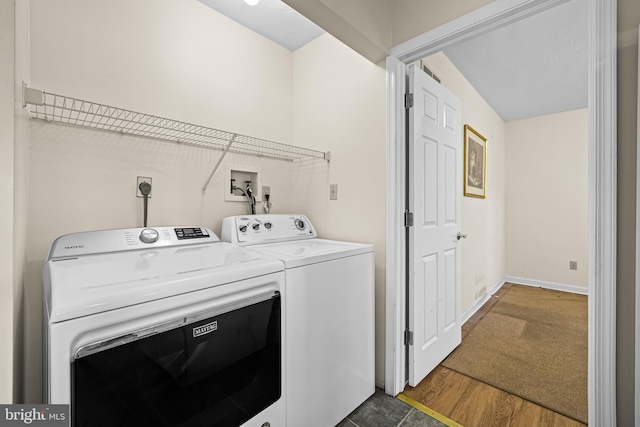 laundry area featuring dark hardwood / wood-style flooring and washer and clothes dryer