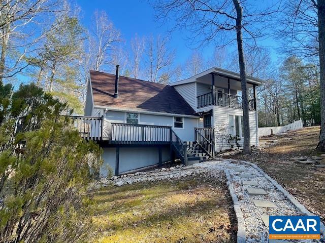 back of property with a balcony and a deck