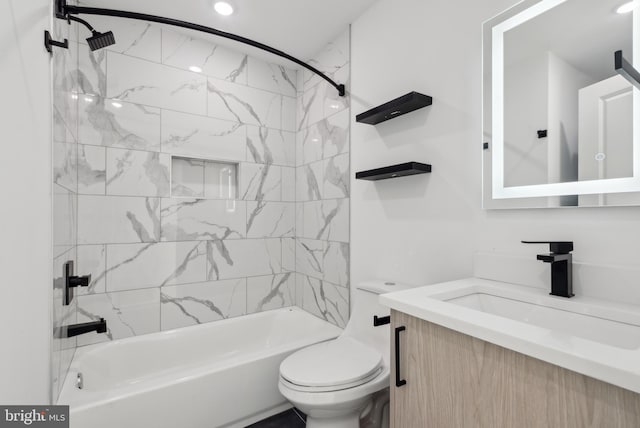 full bathroom with vanity, tiled shower / bath, and toilet