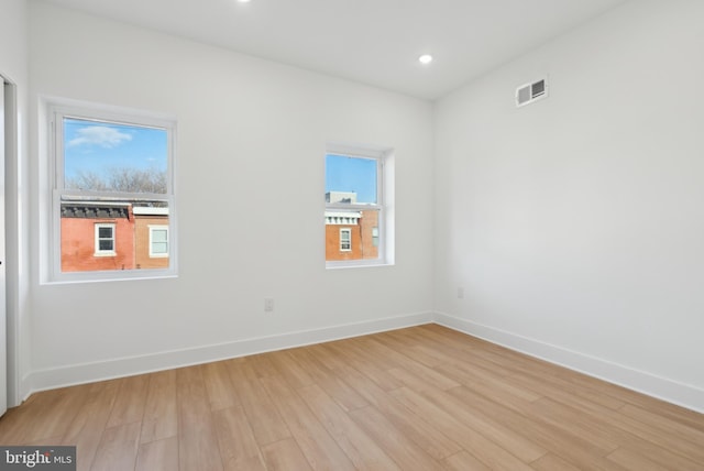 spare room featuring plenty of natural light and light wood-type flooring