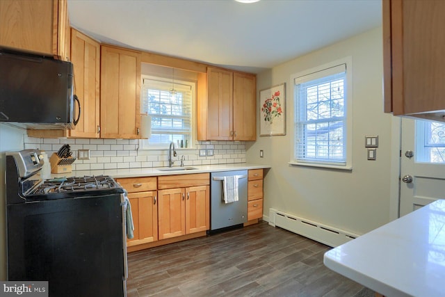 kitchen featuring sink, dark wood-type flooring, a baseboard heating unit, backsplash, and stainless steel appliances