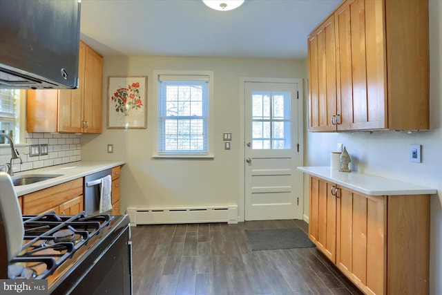 kitchen featuring sink, dark hardwood / wood-style floors, dishwasher, and baseboard heating