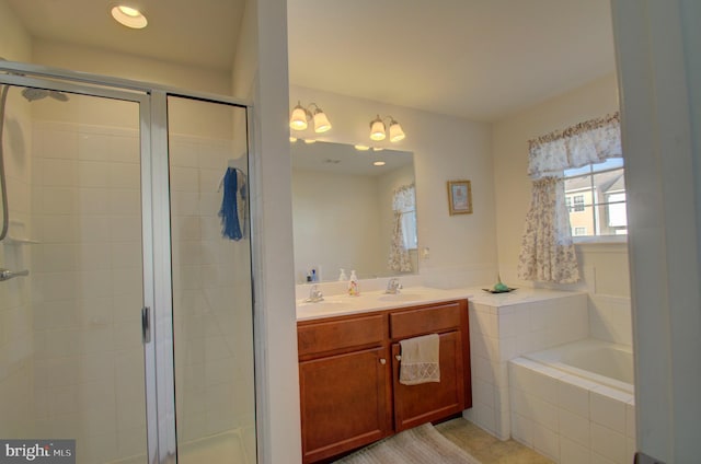 bathroom with separate shower and tub and vanity