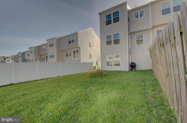 rear view of house with a yard