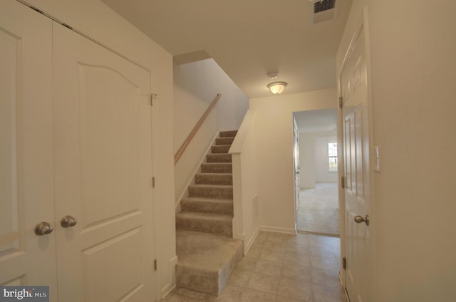 stairs featuring carpet floors