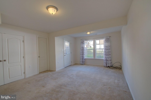 unfurnished bedroom with light colored carpet