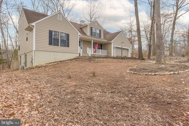 view of front of house featuring a porch and a garage