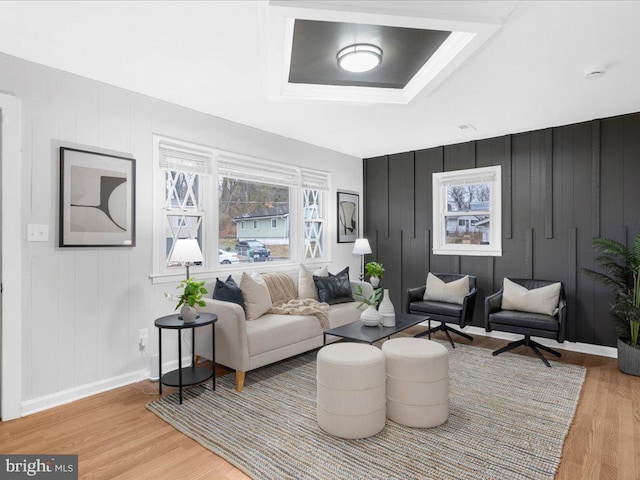 living room featuring a tray ceiling and hardwood / wood-style floors