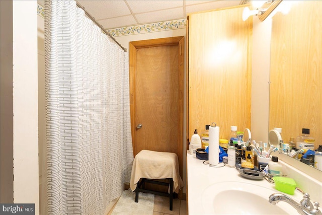 bathroom featuring sink and a drop ceiling