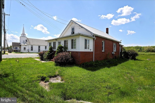 view of side of home featuring a yard