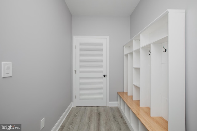 mudroom featuring light wood-style flooring and baseboards