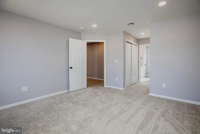 unfurnished bedroom with carpet, recessed lighting, a closet, visible vents, and baseboards