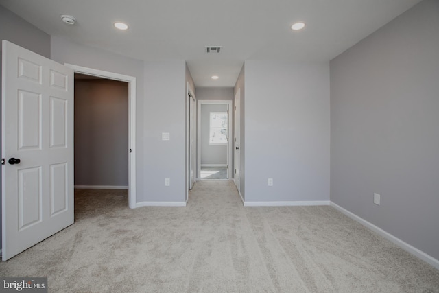 unfurnished bedroom featuring carpet, visible vents, baseboards, and recessed lighting