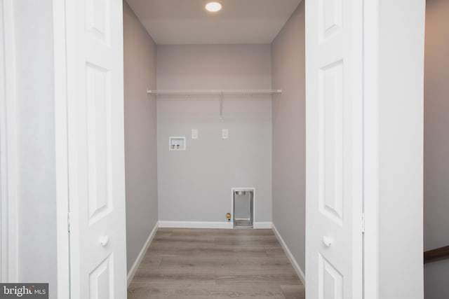 laundry room with washer hookup, hookup for a gas dryer, wood finished floors, laundry area, and baseboards