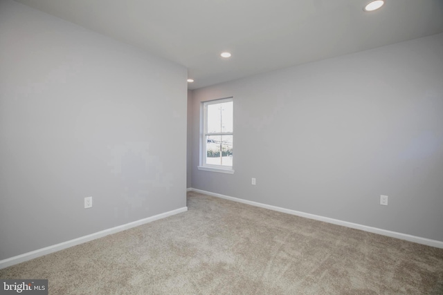 carpeted empty room with recessed lighting and baseboards