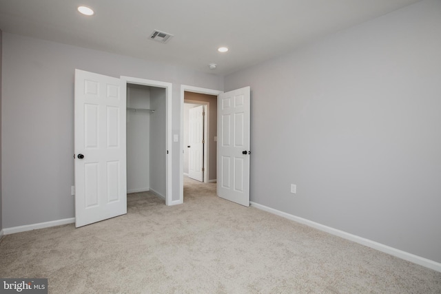 unfurnished bedroom with carpet, visible vents, baseboards, and recessed lighting