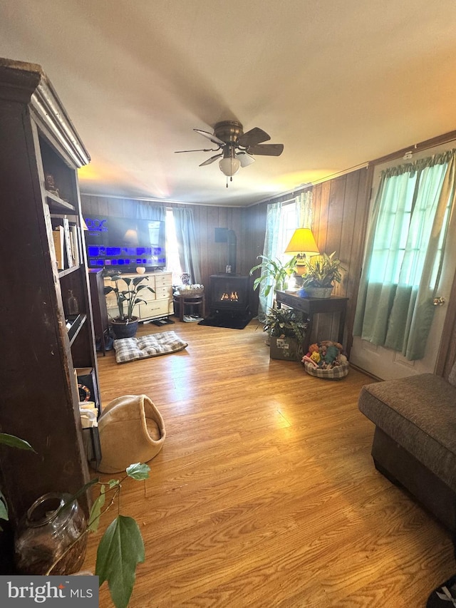 living room with wood-type flooring, ceiling fan, and plenty of natural light