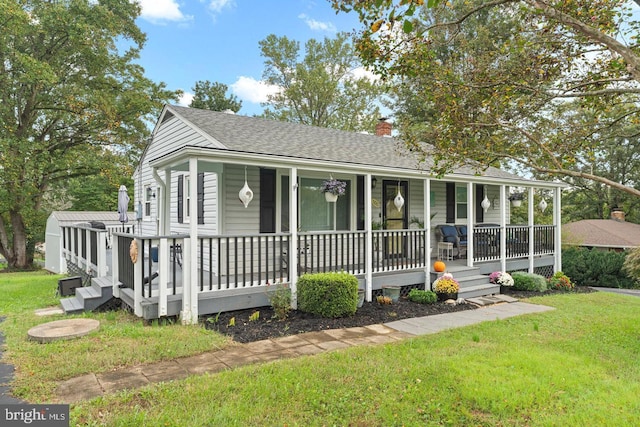 view of front of home with a porch and a front lawn