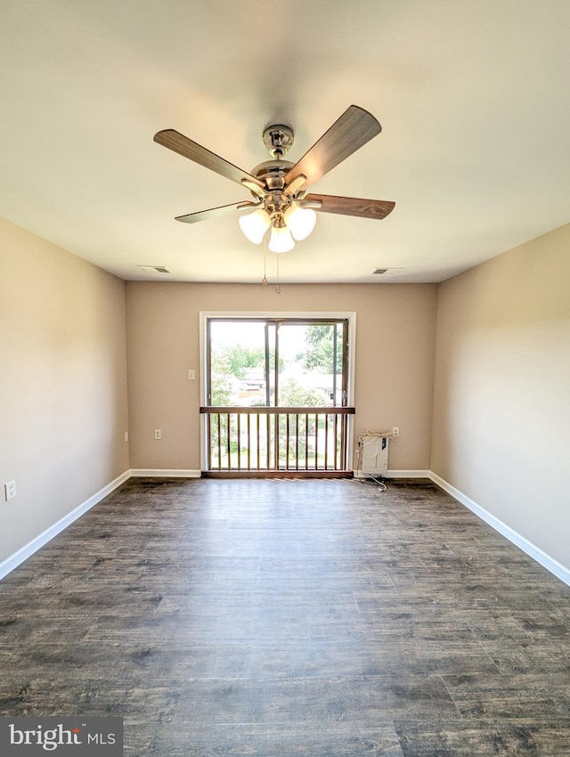 spare room with dark hardwood / wood-style floors and ceiling fan