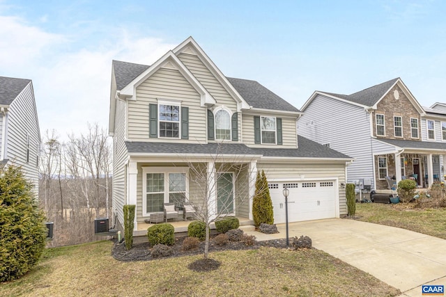 view of front of home featuring a garage, central AC, a front yard, and covered porch