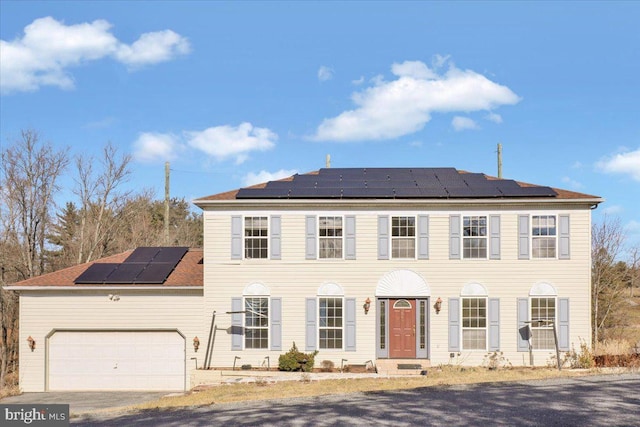 colonial inspired home with a garage