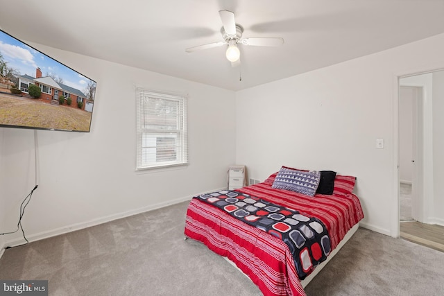 carpeted bedroom with baseboards and a ceiling fan