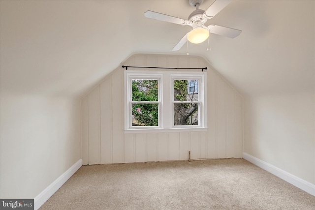 bonus room with lofted ceiling, carpet, and ceiling fan