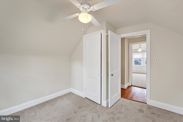 bonus room featuring lofted ceiling, carpet, and baseboards