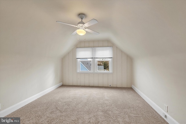 bonus room with baseboards, a ceiling fan, vaulted ceiling, and carpet flooring