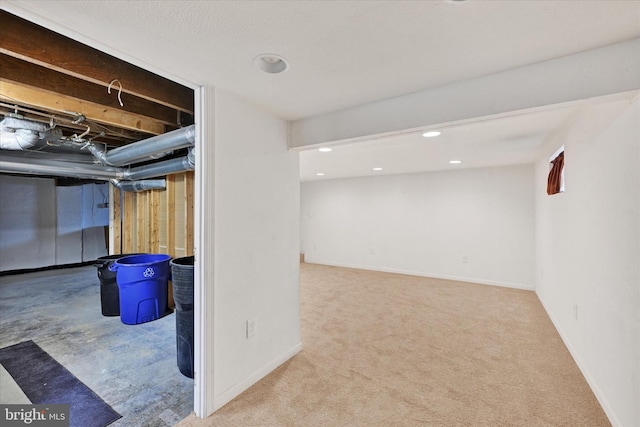 unfinished below grade area with carpet, baseboards, and recessed lighting