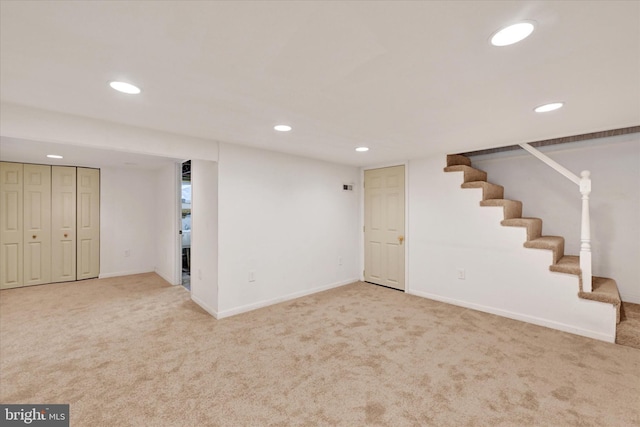 finished basement with carpet, stairway, baseboards, and recessed lighting