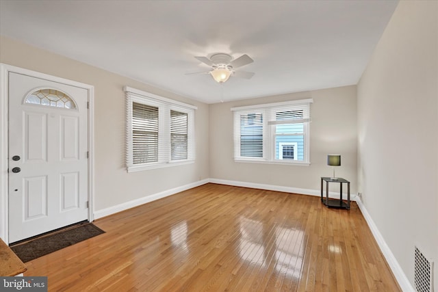 foyer entrance featuring a ceiling fan, light wood-type flooring, visible vents, and baseboards