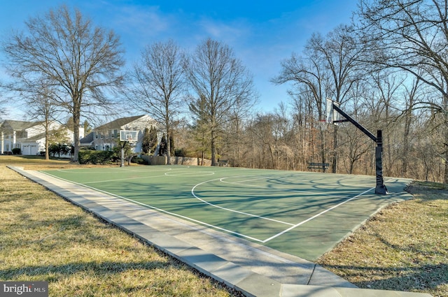 view of basketball court with community basketball court and a lawn