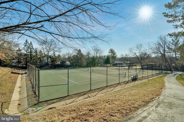 view of sport court featuring fence