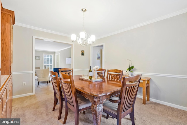 dining area with light carpet, baseboards, ornamental molding, and a notable chandelier