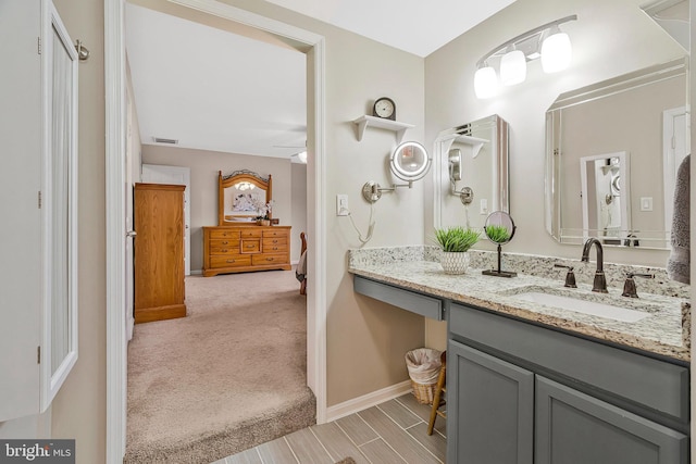 bathroom featuring a ceiling fan, visible vents, vanity, and baseboards