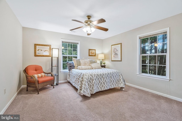 carpeted bedroom featuring ceiling fan and baseboards