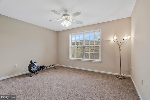 interior space with carpet flooring, a ceiling fan, and baseboards