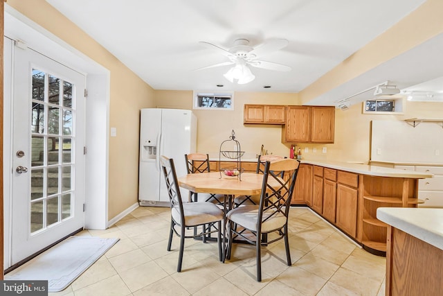 dining area with a ceiling fan, a healthy amount of sunlight, and light tile patterned floors