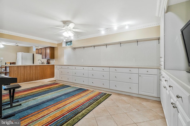 interior space with light tile patterned floors, white cabinets, freestanding refrigerator, light countertops, and open shelves