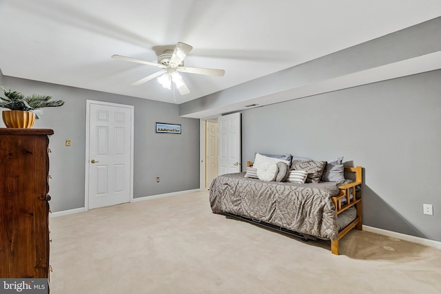 carpeted bedroom featuring a ceiling fan and baseboards