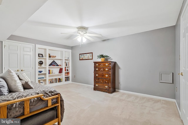 bedroom with light carpet, ceiling fan, and baseboards